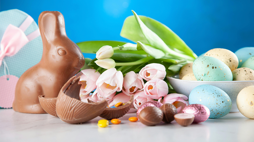 White Flowers Between Brown Rabbit Figure and Eggs